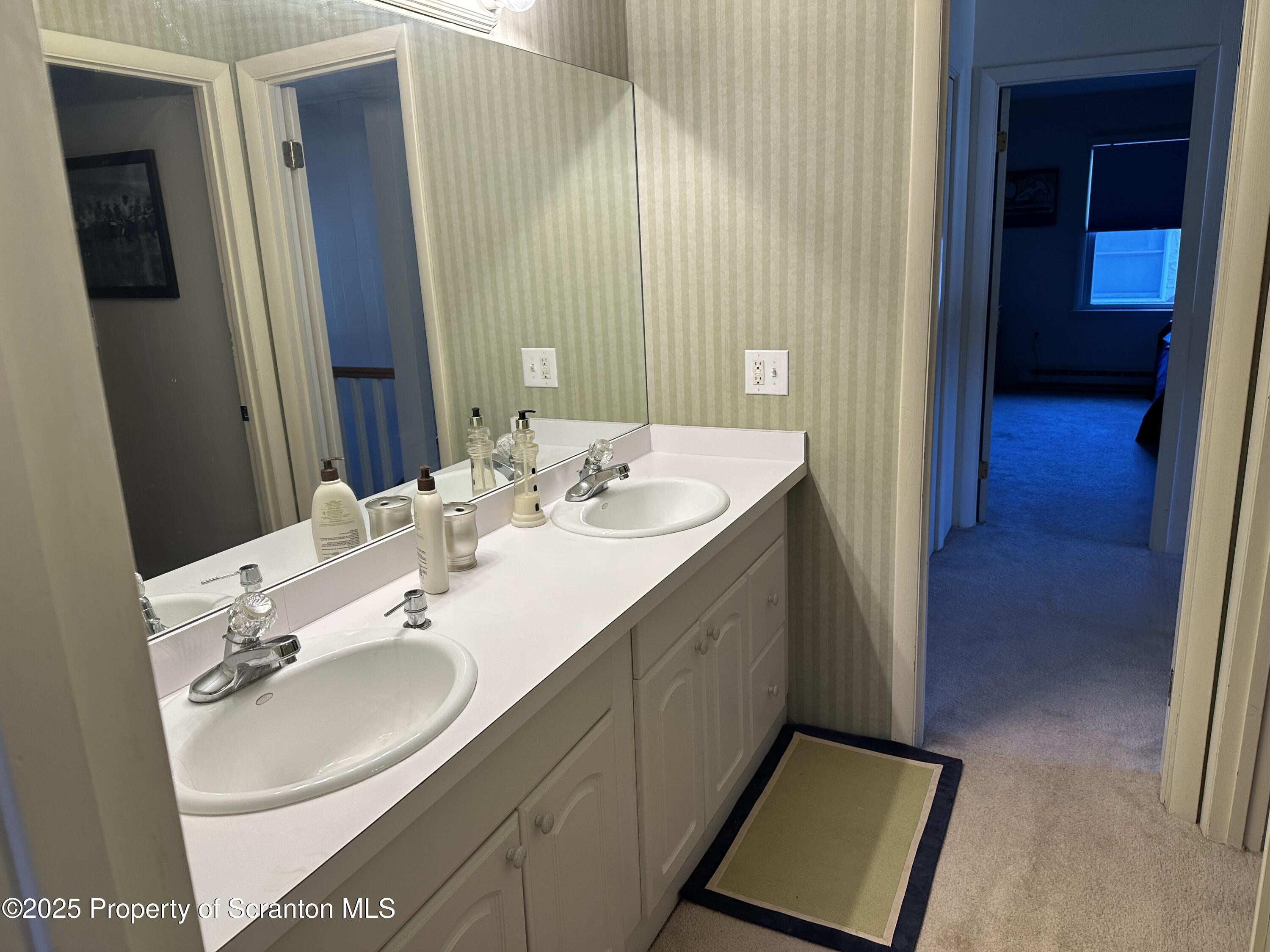 R-1 Ralph Lomma Way Union Dale, PA 18470 - Photo 20 of 25 a en suite bathroom with a double vanity sink and a mirror