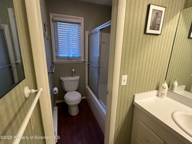 a bathroom with a granite countertop toilet sink and a mirror