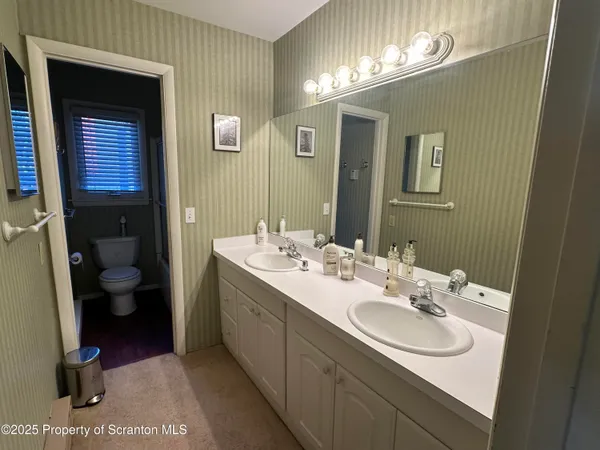 a bathroom with a double vanity sink and a mirror