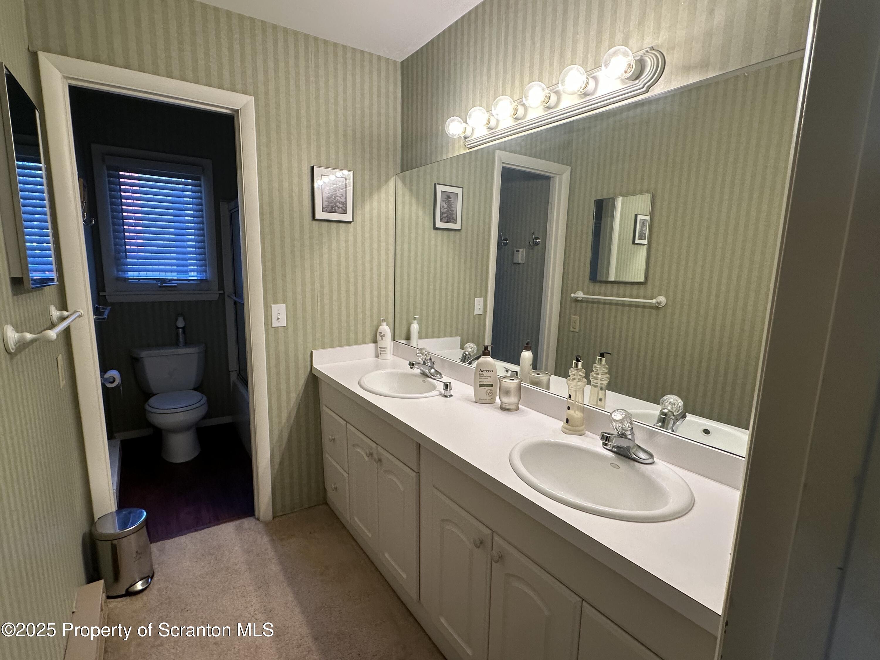 R-1 Ralph Lomma Way Union Dale, PA 18470 - Photo 22 of 25 a bathroom with a double vanity sink and a mirror