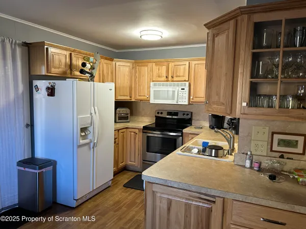 a kitchen with a refrigerator and a stove top oven