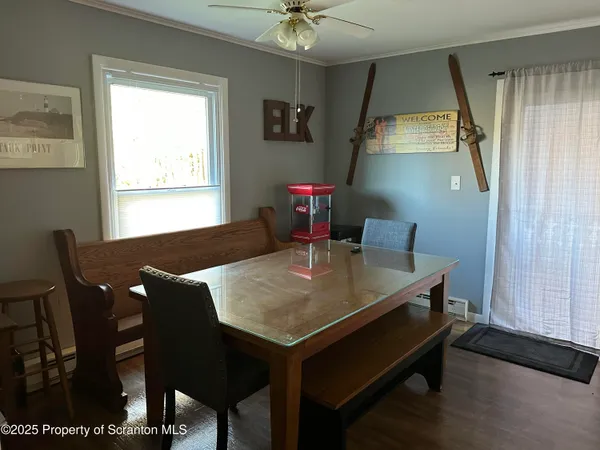 a view of a dining room with furniture and a window