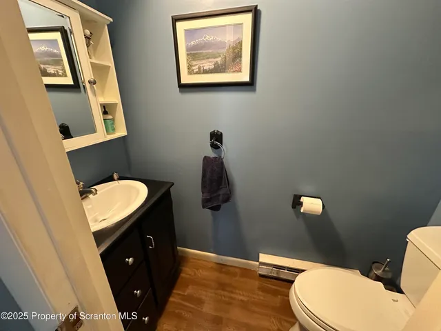 a bathroom with a toilet a sink and mirror