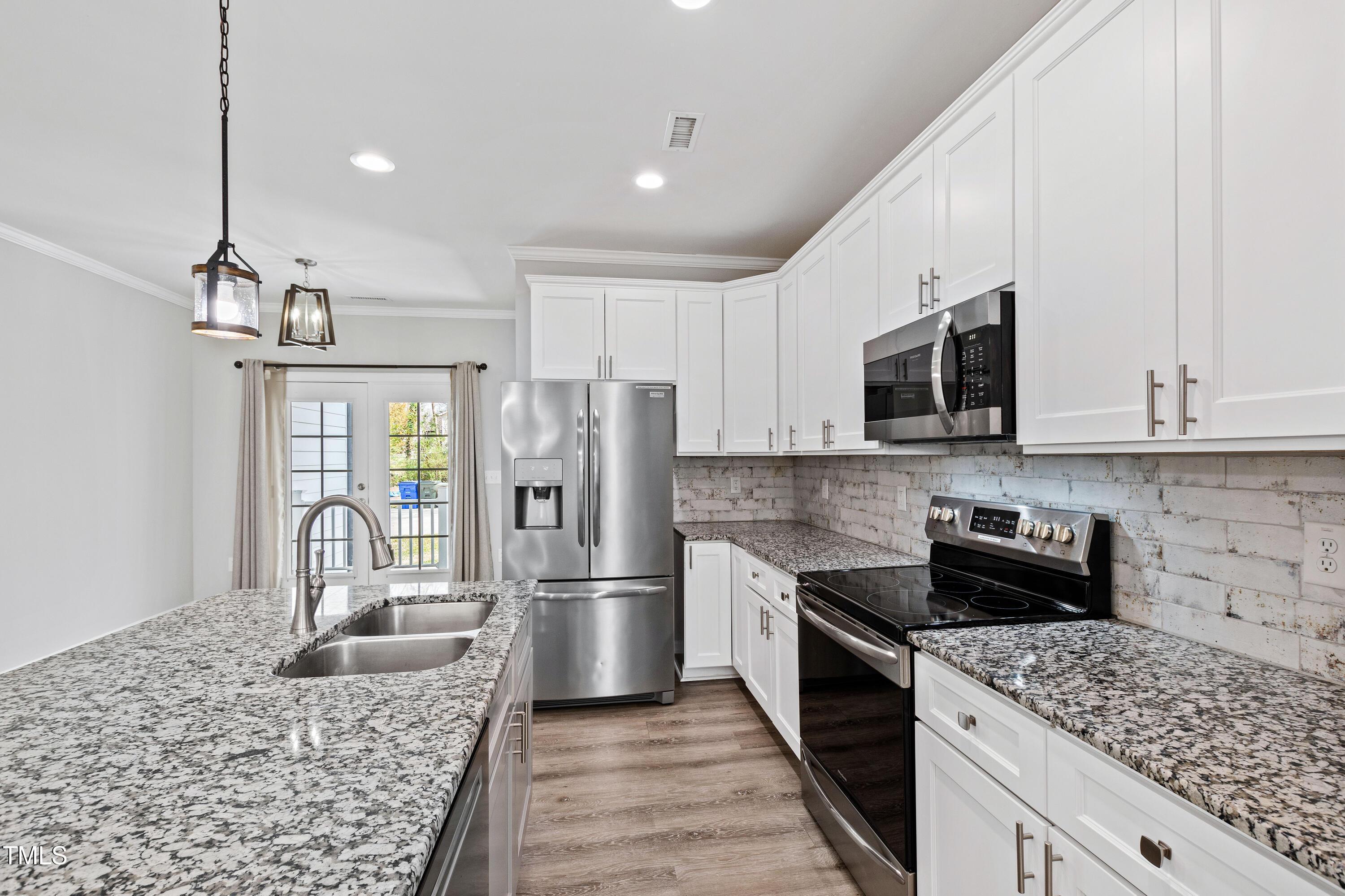 512 Spruce Street, Unit A Durham, NC 27703 - Photo 11 of 36 a kitchen with a refrigerator sink and microwave