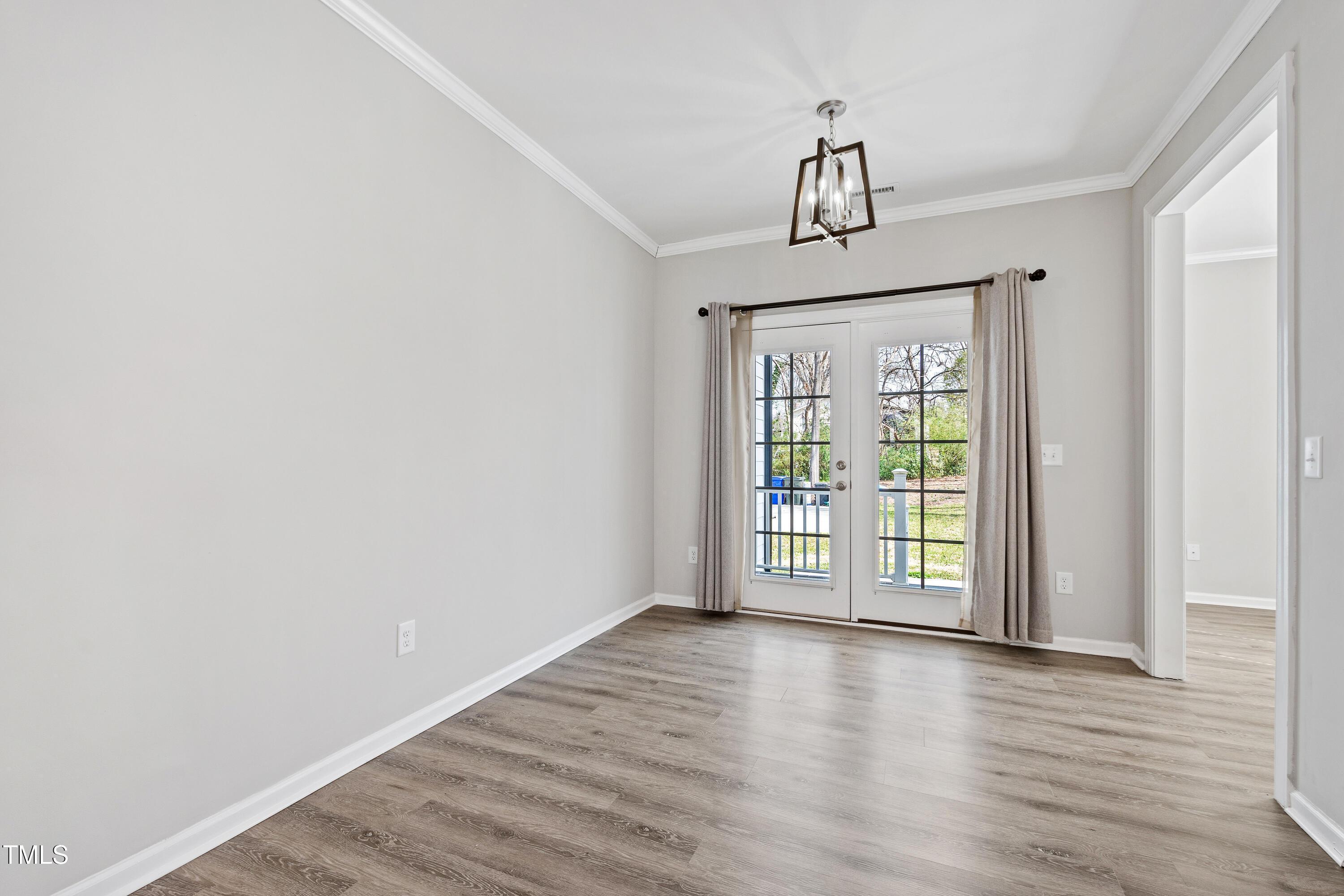 512 Spruce Street, Unit A Durham, NC 27703 - Photo 13 of 36 a view of an empty room with wooden floor and a window