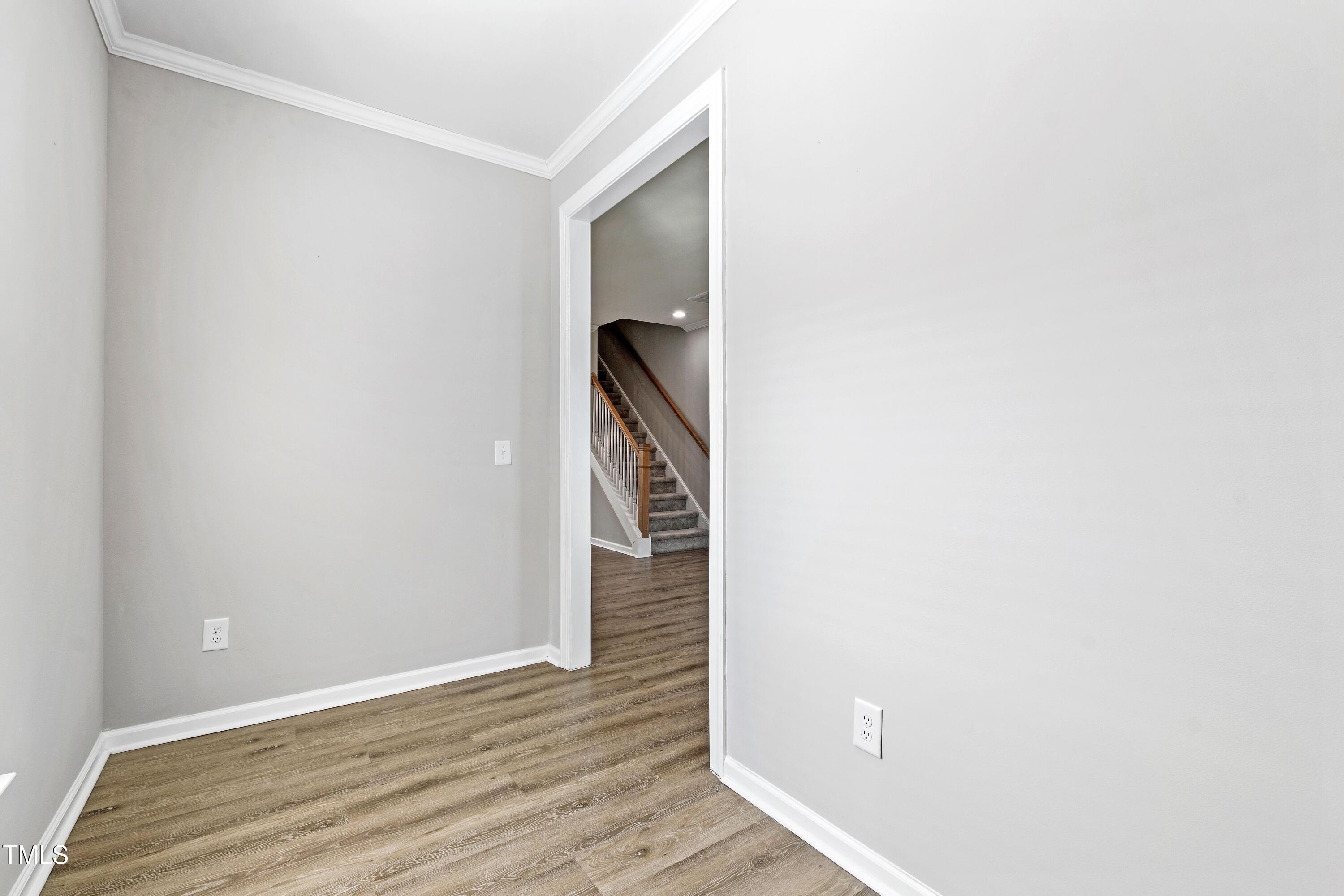 512 Spruce Street, Unit A Durham, NC 27703 - Photo 15 of 36 a view of a hallway with wooden floor and staircase
