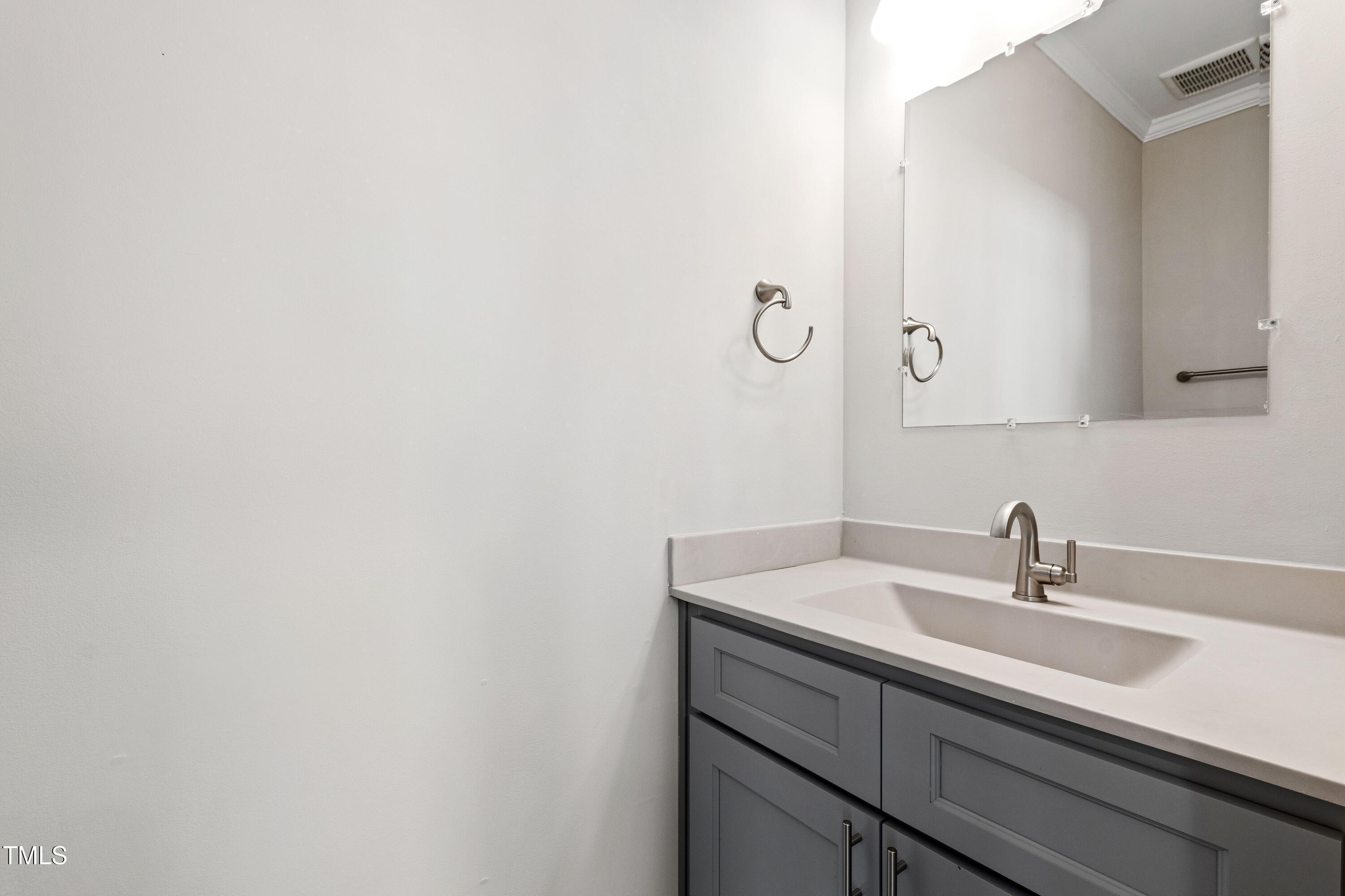 512 Spruce Street, Unit A Durham, NC 27703 - Photo 16 of 36 a bathroom with a sink and mirror