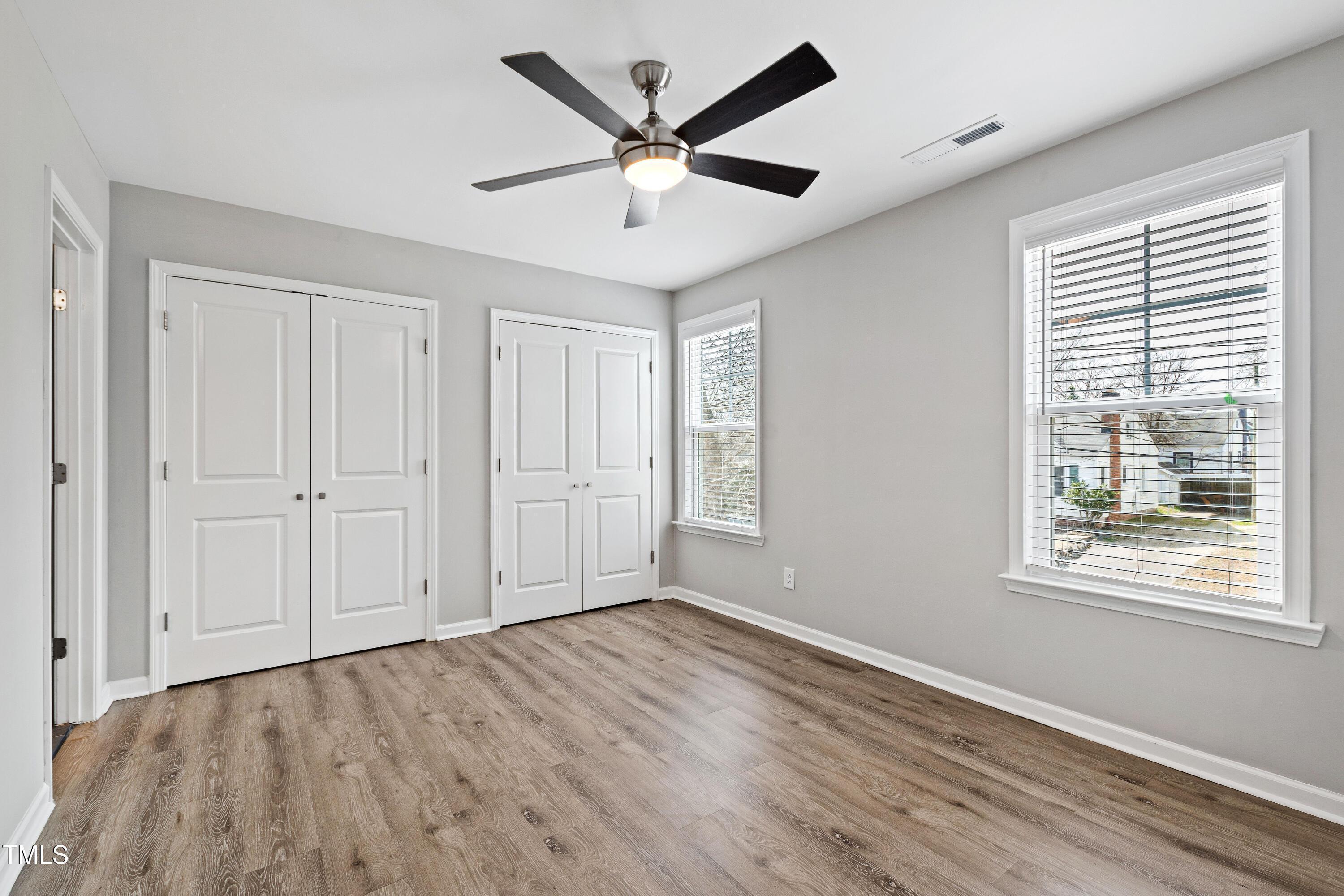 512 Spruce Street, Unit A Durham, NC 27703 - Photo 18 of 36 a view of an empty room with wooden floor and a window