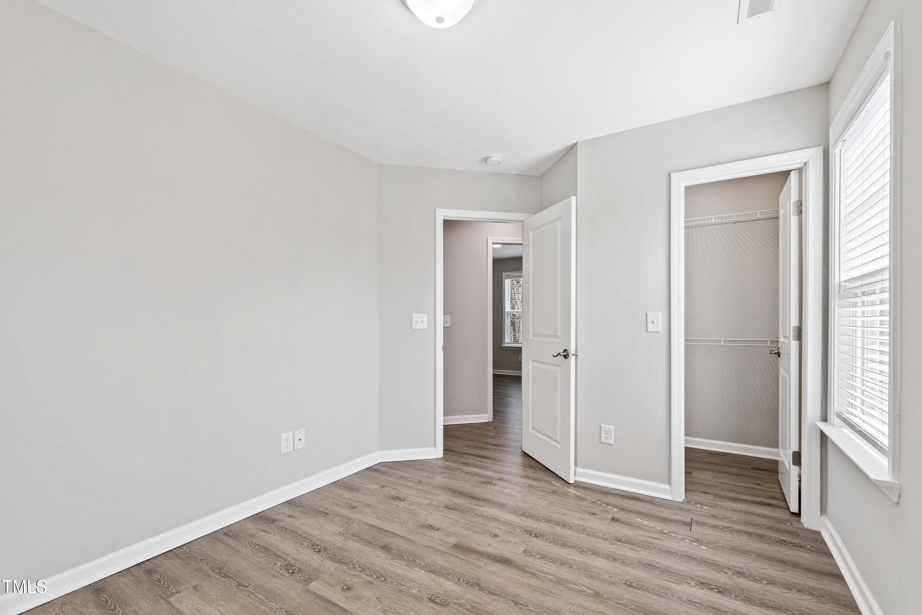 512 Spruce Street, Unit A Durham, NC 27703 - Photo 24 of 36 a view of an empty room with wooden floor and a window
