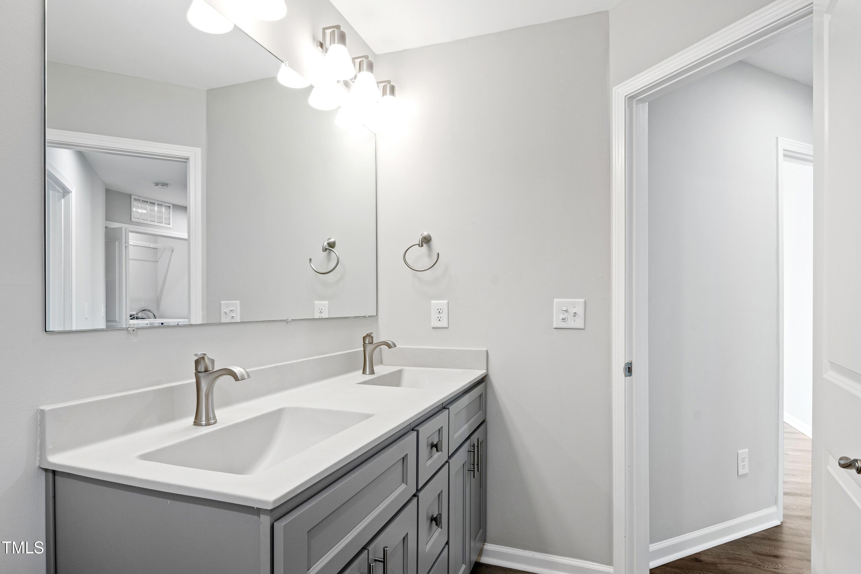 512 Spruce Street, Unit A Durham, NC 27703 - Photo 26 of 36 a bathroom with a sink vanity and a mirror