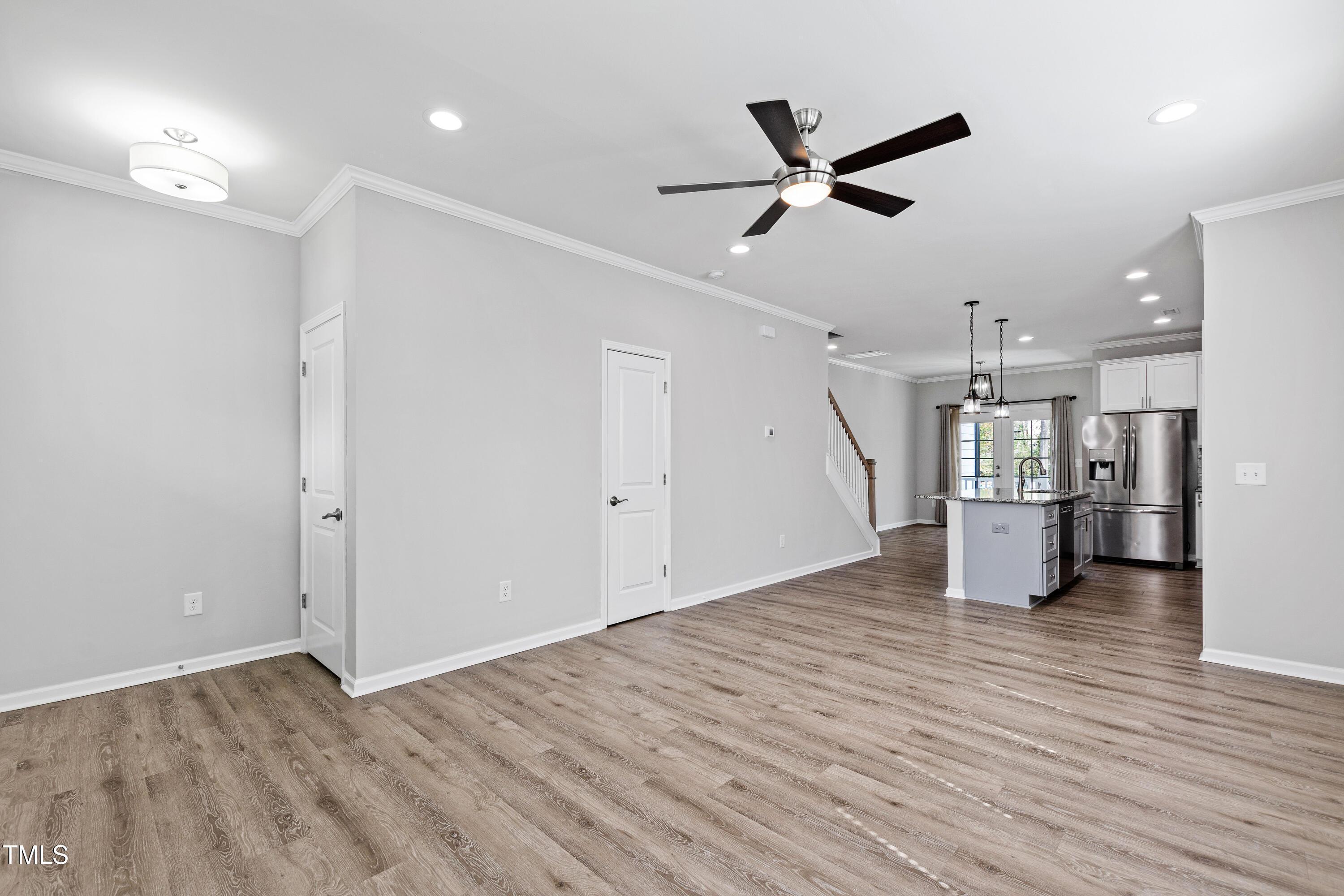 512 Spruce Street, Unit A Durham, NC 27703 - Photo 4 of 36 a view of empty room with wooden floor and ceiling fan