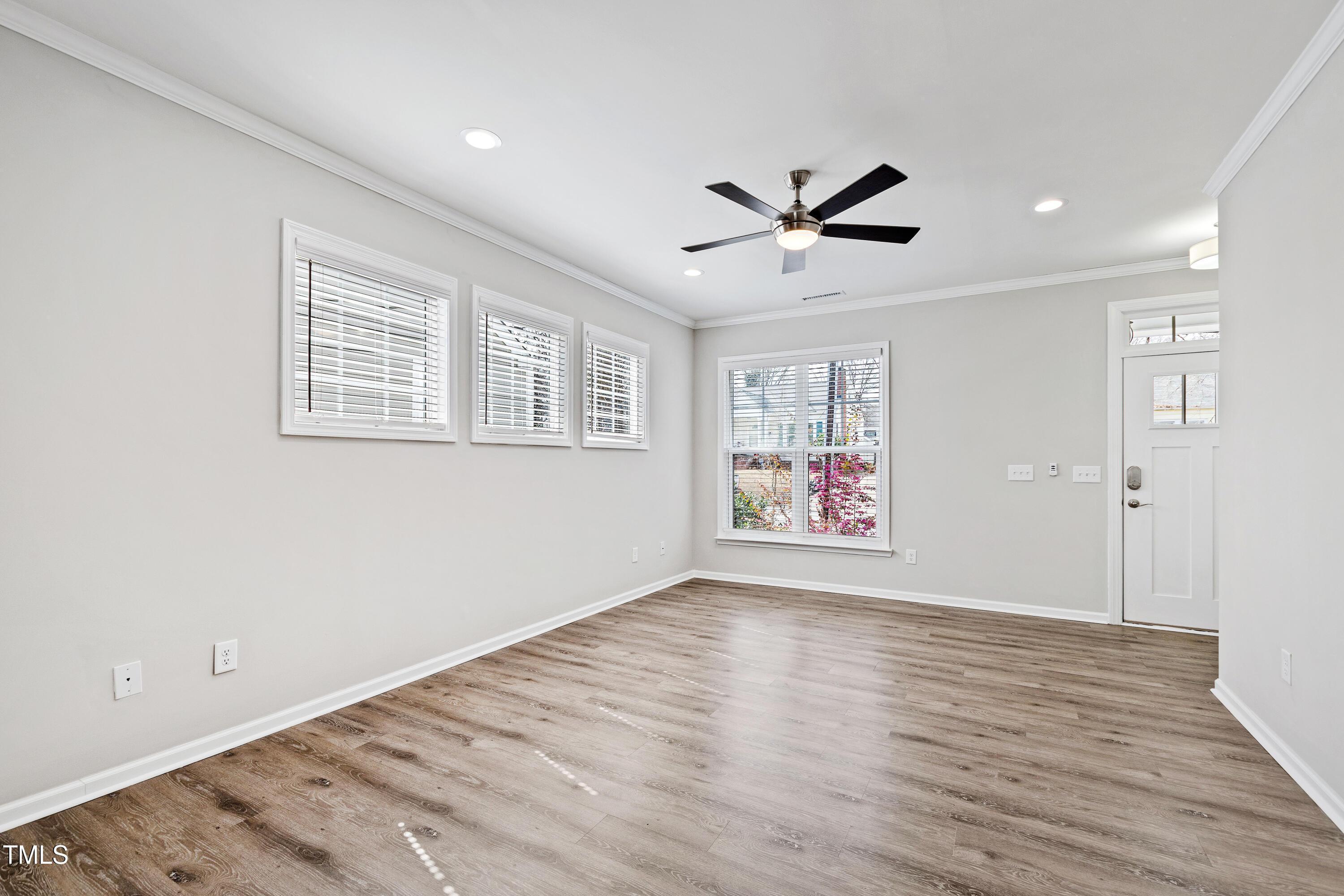 512 Spruce Street, Unit A Durham, NC 27703 - Photo 6 of 36 a view of an empty room with a window and wooden floor