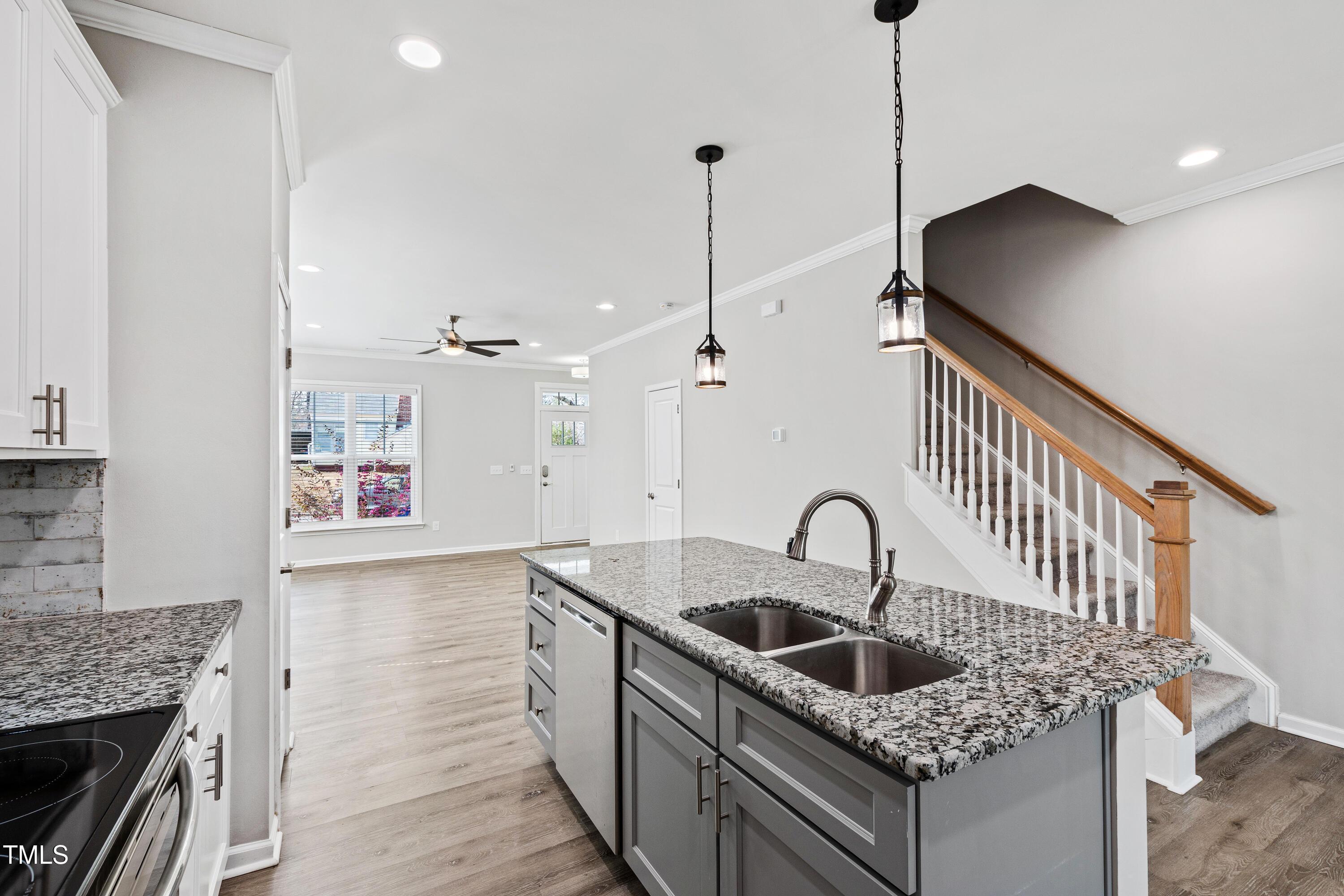 512 Spruce Street, Unit A Durham, NC 27703 - Photo 9 of 36 a kitchen with granite countertop a sink a stove and refrigerator