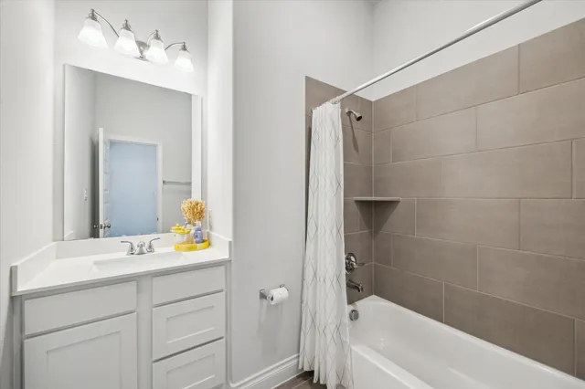 a bathroom with a tub sink and mirror