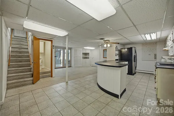 a kitchen with a refrigerator and a sink