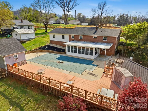 a view of a house with wooden deck and furniture