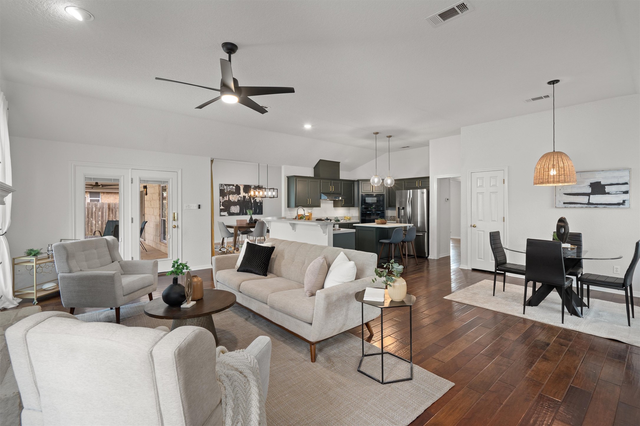 1014 Hackberry Drive Pflugerville, TX 78660 - Photo 35 of 36 a living room with furniture kitchen view and a chandelier