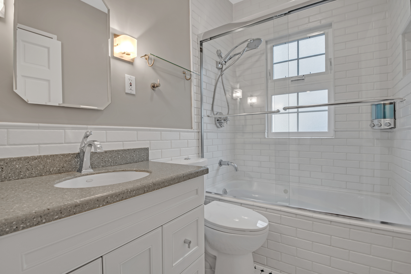 657 Chestnut Street Deerfield, IL 60015 - Photo 14 of 25 a bathroom with a granite countertop sink a toilet and shower