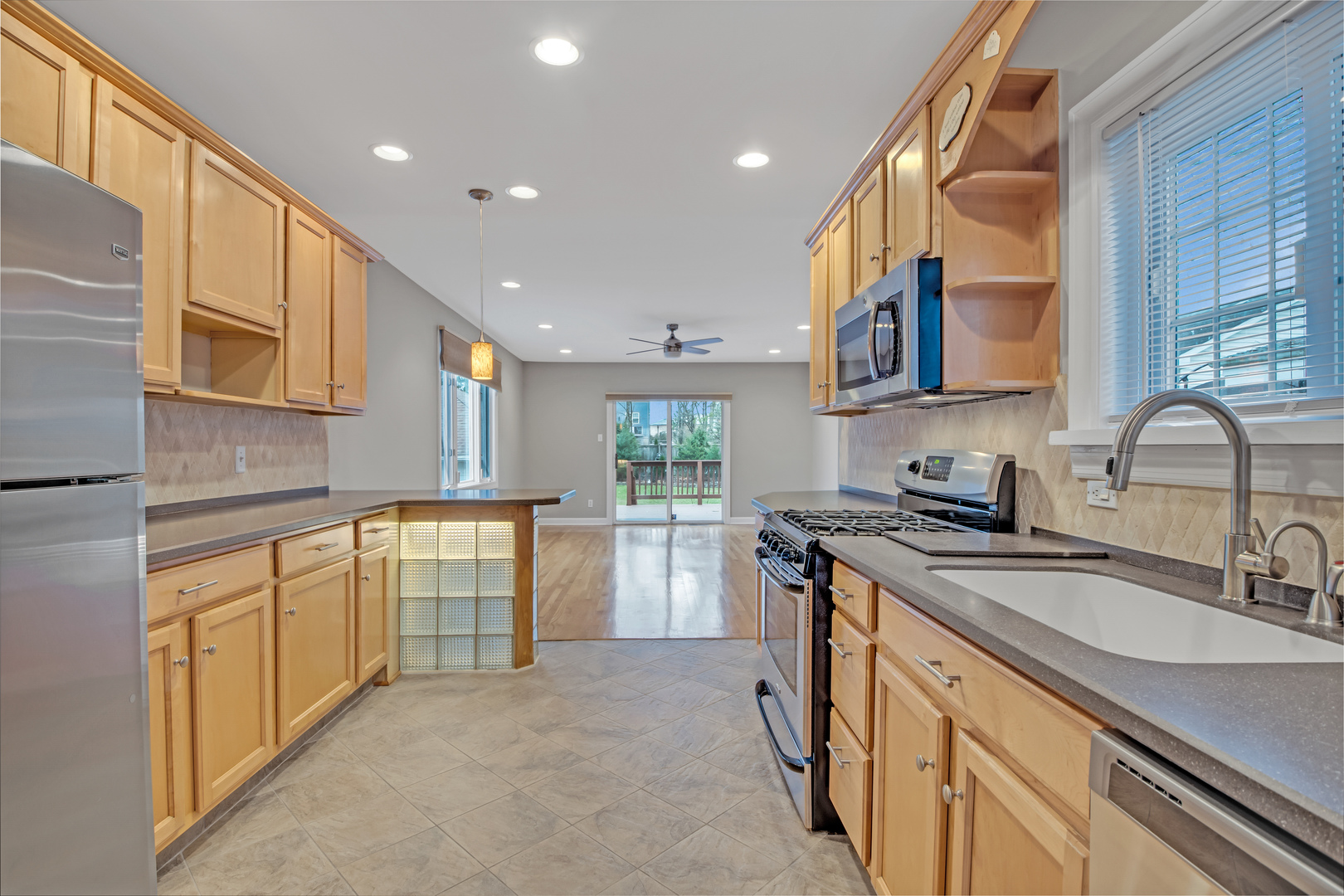 657 Chestnut Street Deerfield, IL 60015 - Photo 5 of 25 a kitchen with a sink stove and cabinets