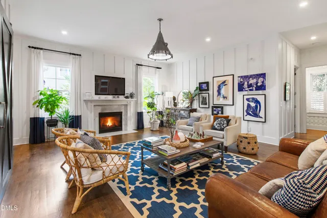 a living room with furniture a flat screen tv and a fireplace