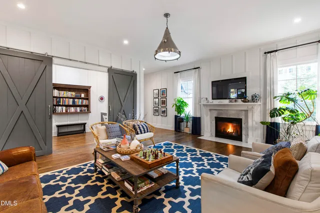 a living room with furniture a flat screen tv and a fireplace