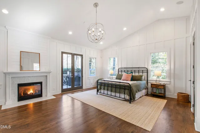 a spacious bedroom with a bed and a fireplace