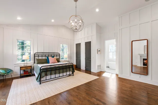 a living room with furniture fireplace and wooden floor