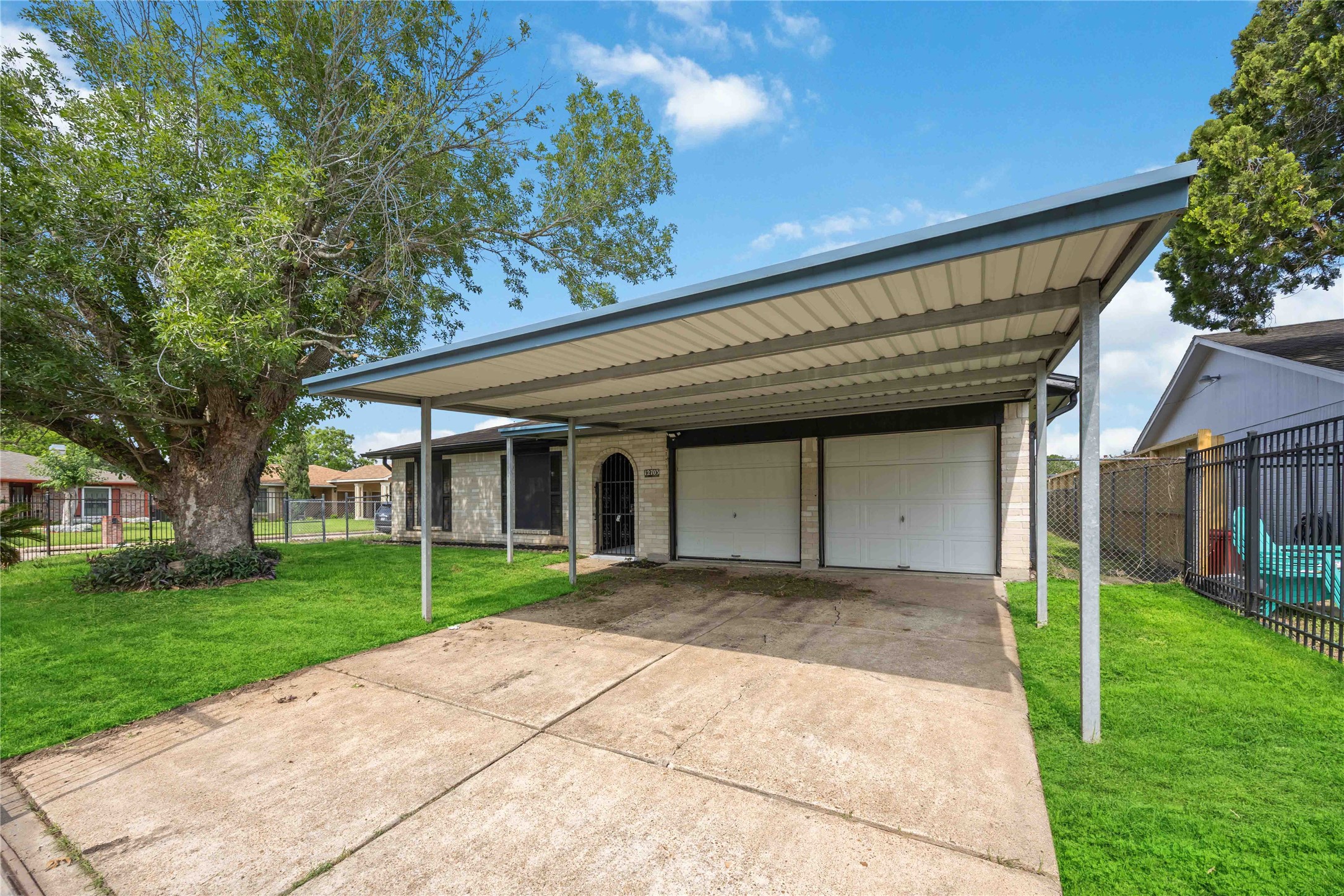 12703 Redfern Drive Houston, TX 77048 - Photo 26 of 28 Extended driveway with covered parking and dual garage access—providing ample space for vehicles, storage, or future enhancements tailored to your lifestyle.