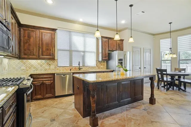 a kitchen with stainless steel appliances granite countertop a sink and cabinets