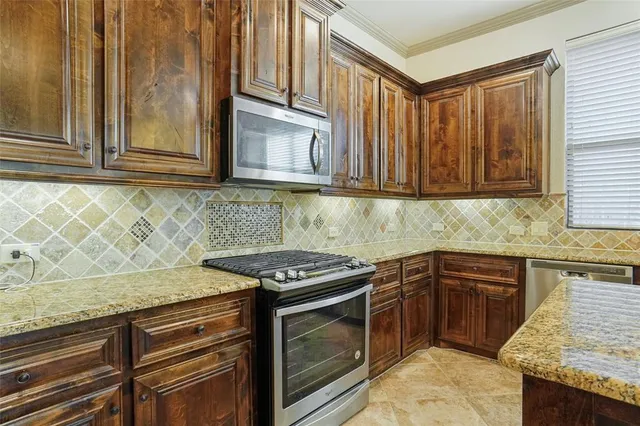 a kitchen with sink stove and cabinets