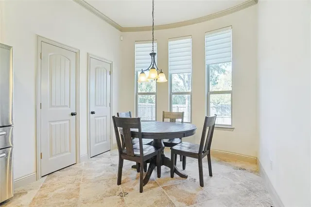 a view of a dining room with furniture and a window