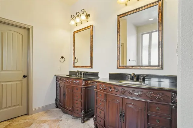 a spacious bathroom with a tub a sink and a mirror