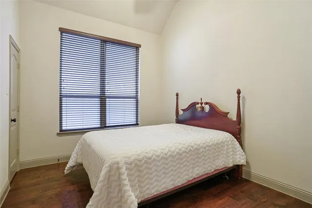 a view of a room that has a bed in it