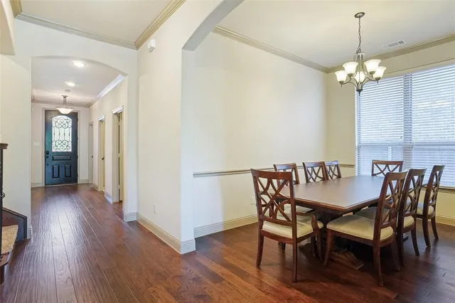 a view of a dining room with furniture wooden floor and chandelier