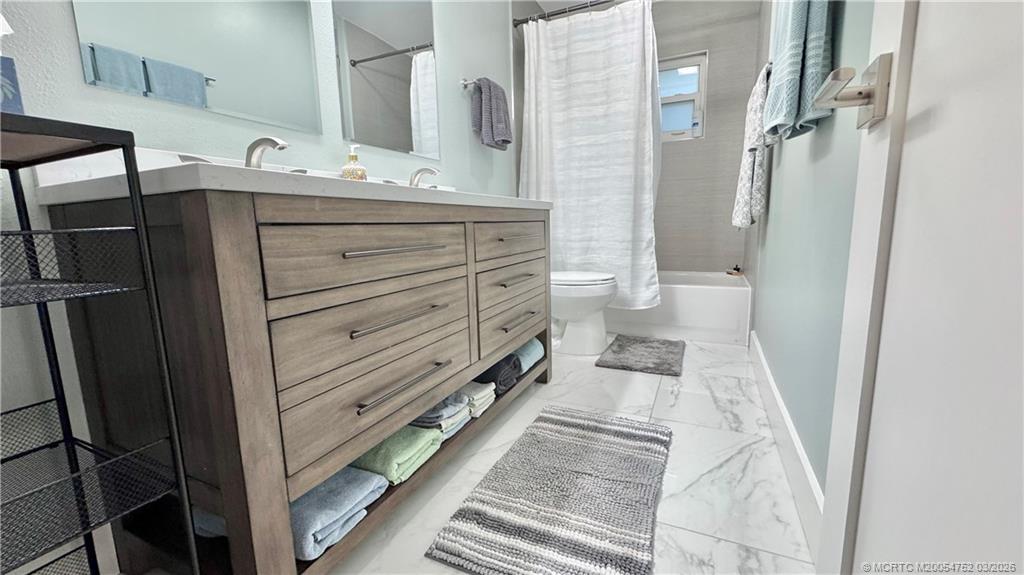 323 Southwest Ridge Lane Stuart, FL 34994 - Photo 11 of 18 a bathroom with a sink a toilet and shower