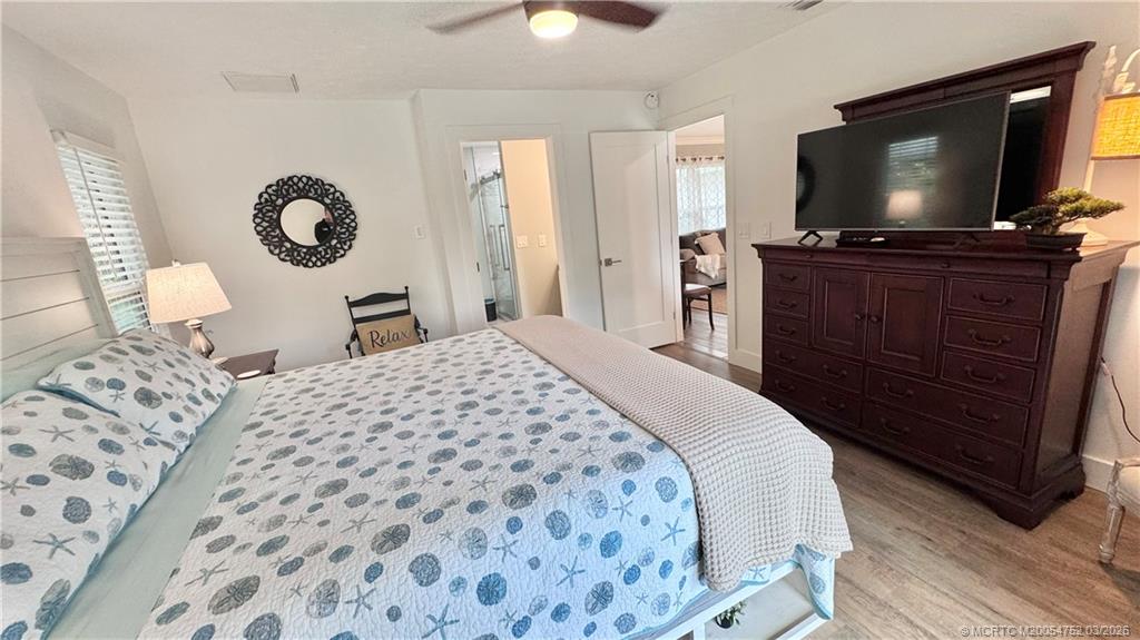 323 Southwest Ridge Lane Stuart, FL 34994 - Photo 6 of 18 a bedroom with a bed and a flat tv screen on dresser