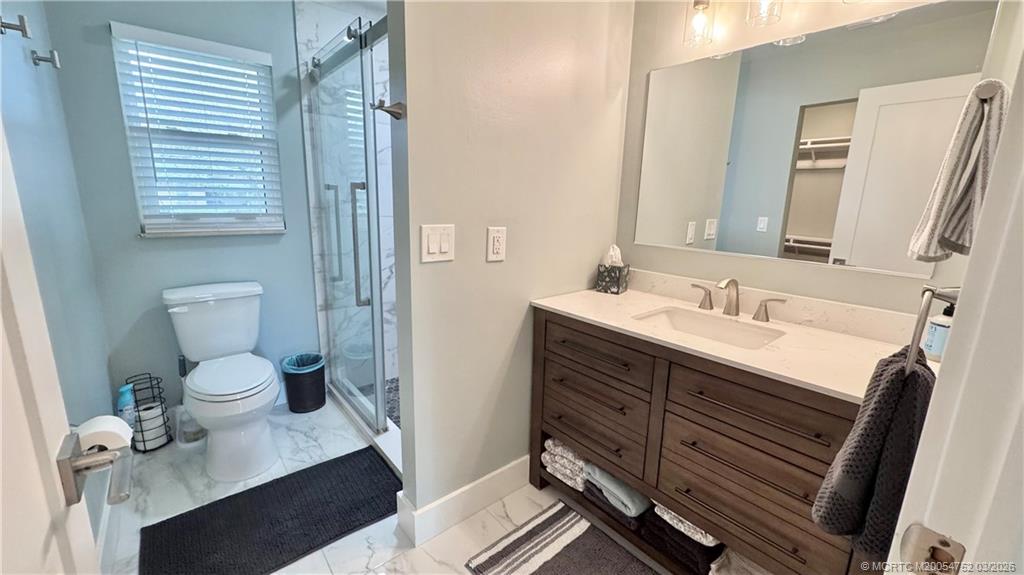 323 Southwest Ridge Lane Stuart, FL 34994 - Photo 7 of 18 a bathroom with a sink vanity granite and toilet