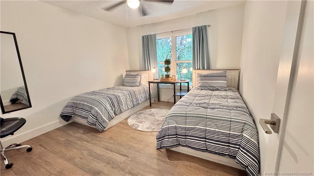 323 Southwest Ridge Lane Stuart, FL 34994 - Photo 9 of 18 a bedroom with two beds and a large window