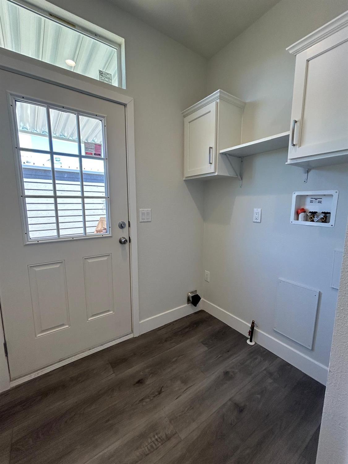 9060 Auburn Folsom Road, Unit 25 Granite Bay, CA 95746 - Photo 14 of 29 an empty room with wooden floor and windows
