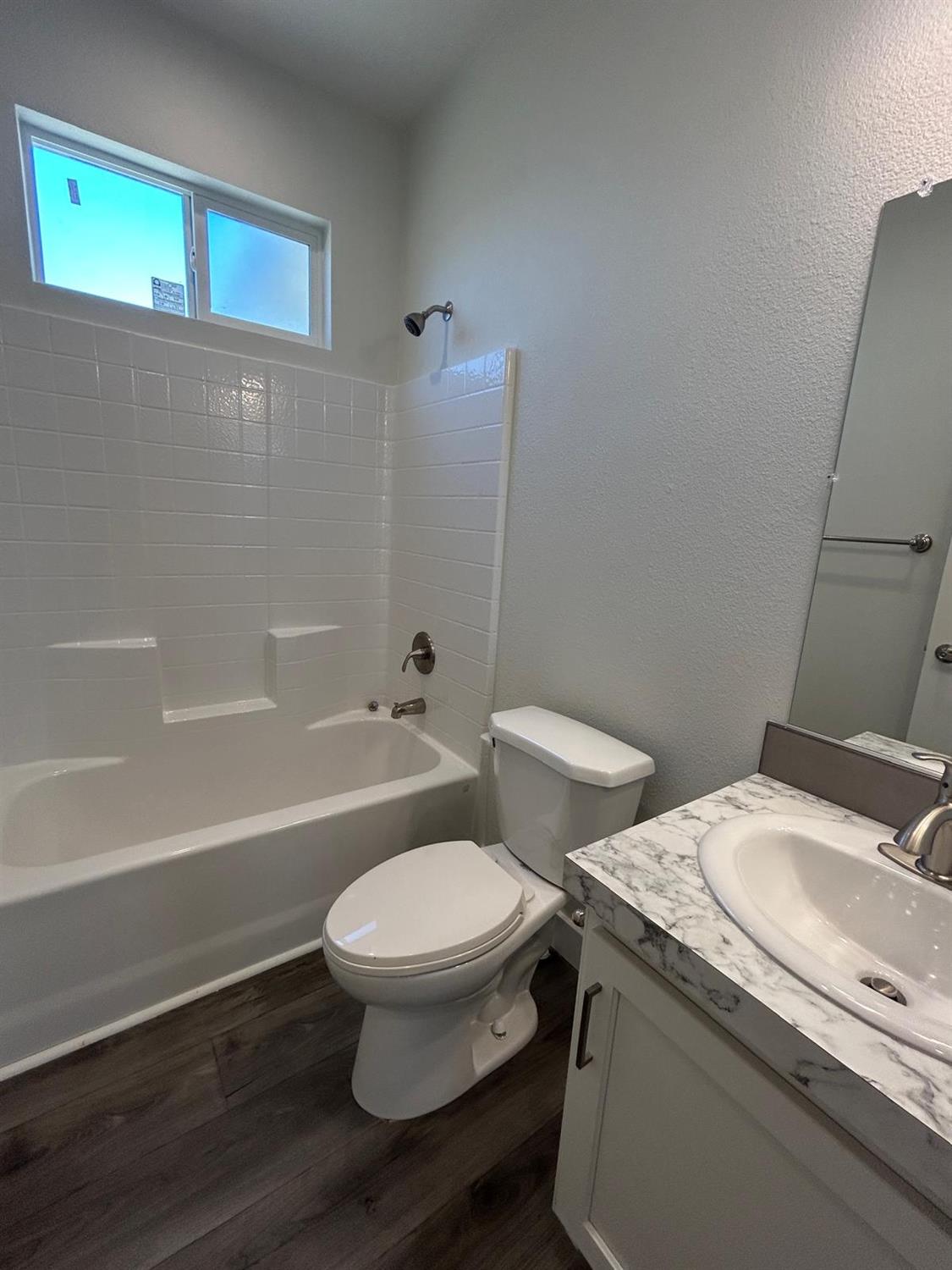 9060 Auburn Folsom Road, Unit 25 Granite Bay, CA 95746 - Photo 19 of 29 a bathroom with a granite countertop toilet a sink and bathtub