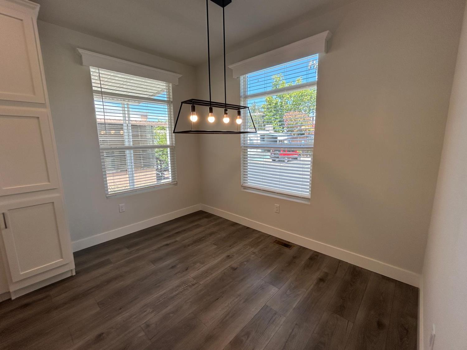 9060 Auburn Folsom Road, Unit 25 Granite Bay, CA 95746 - Photo 9 of 29 a view of an empty room with wooden floor and a window