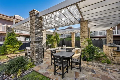 a view of a patio with table and chairs and potted plants