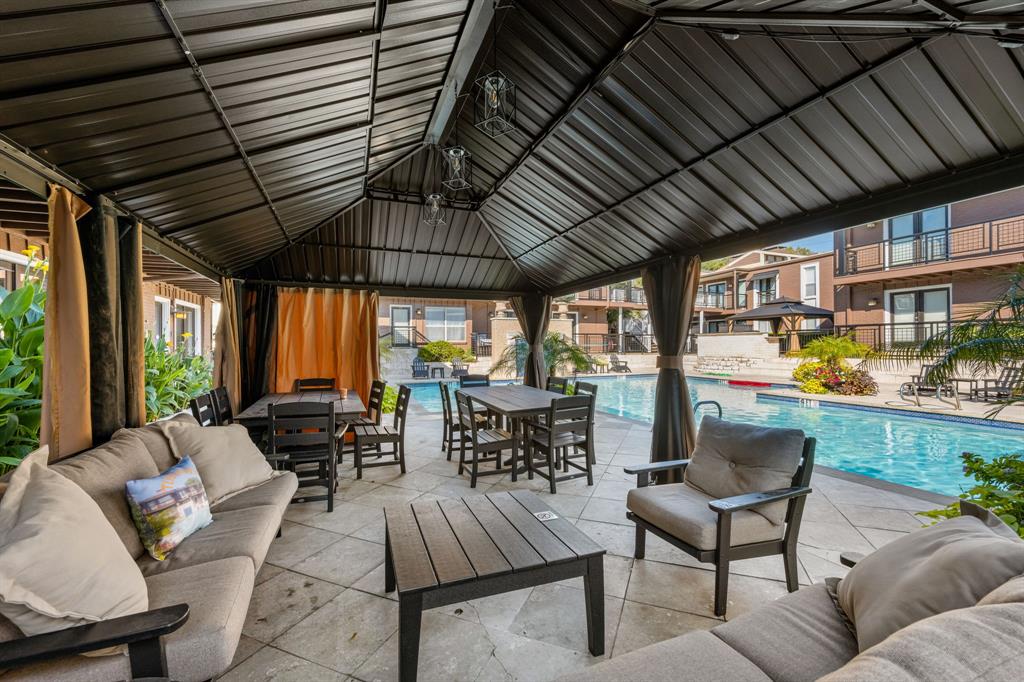 5934 Sandhurst Lane, Unit 109 Dallas, TX 75206 - Photo 14 of 15 a living room with furniture and a wooden floor