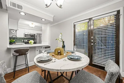 a view of a dining room with furniture and window
