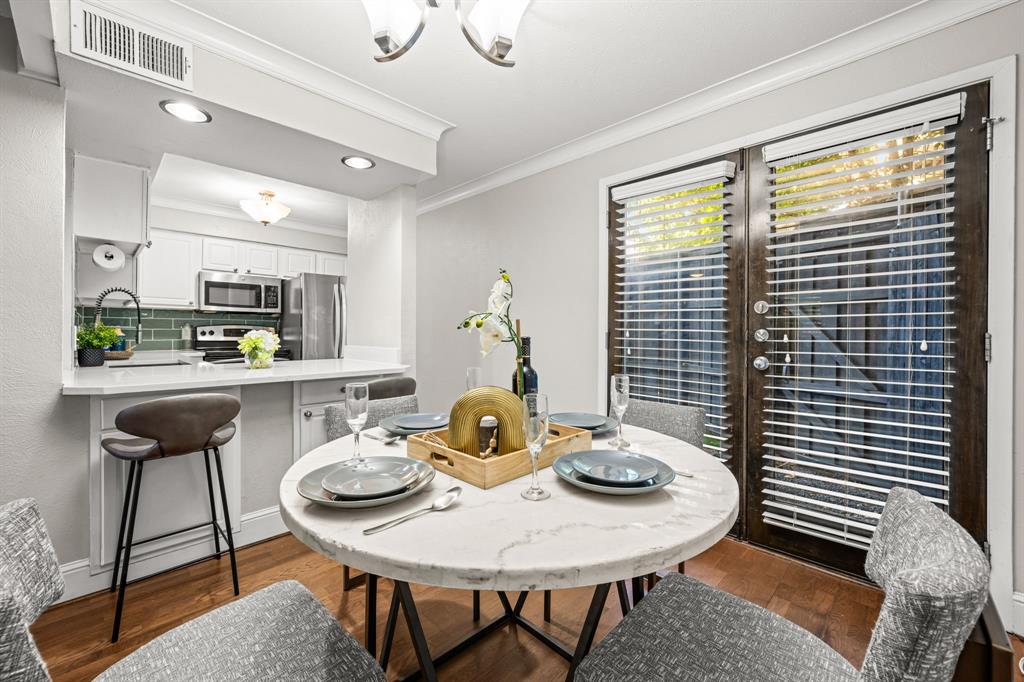 5934 Sandhurst Lane, Unit 109 Dallas, TX 75206 - Photo 4 of 15 a view of a dining room with furniture and window
