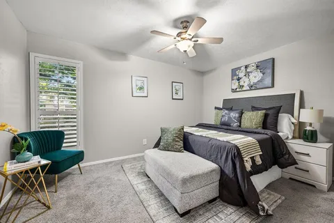 a bedroom with a bed and window