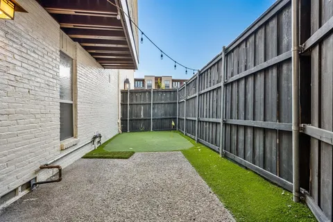 a view of a backyard with wooden fence