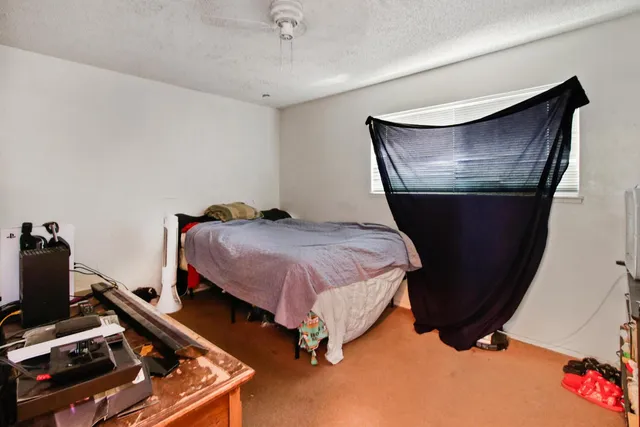 a bedroom with a bed and a window