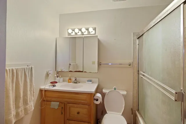 a bathroom with a toilet sink and mirror
