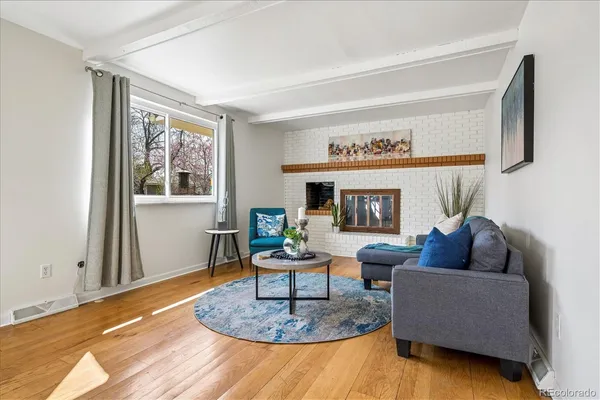 a living room with furniture and a potted plant